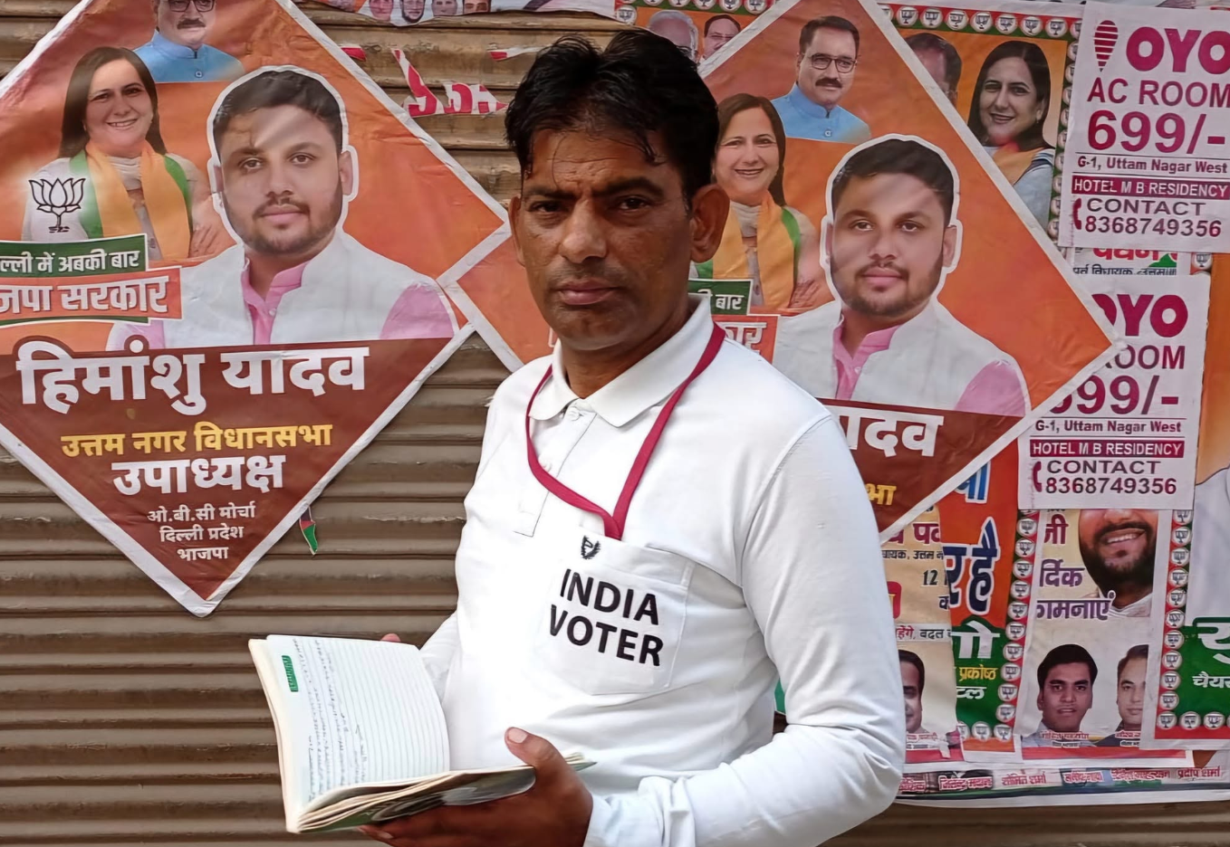 Vijay Godara holding survey register notebook in Uttam Nagar Delhi